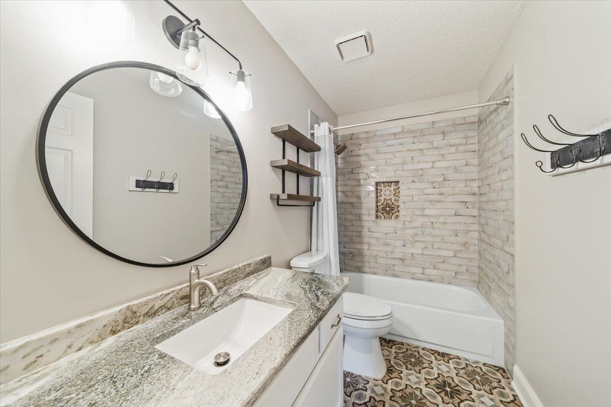 3204 Falling Star Cove Bartlett, TN 38134 - Photo 24 of 36 a bathroom with a sink a toilet and a mirror