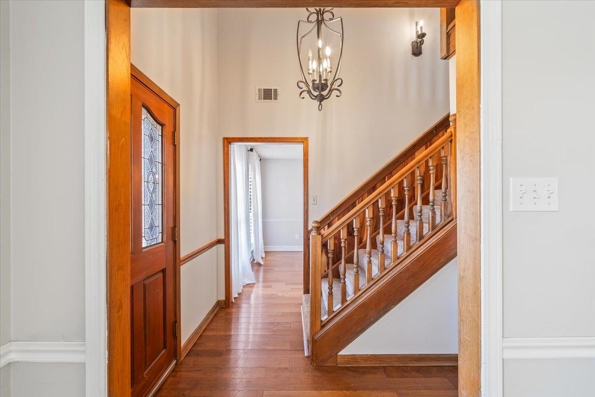3204 Falling Star Cove Bartlett, TN 38134 - Photo 3 of 36 a view of a hallway with wooden floor and staircase