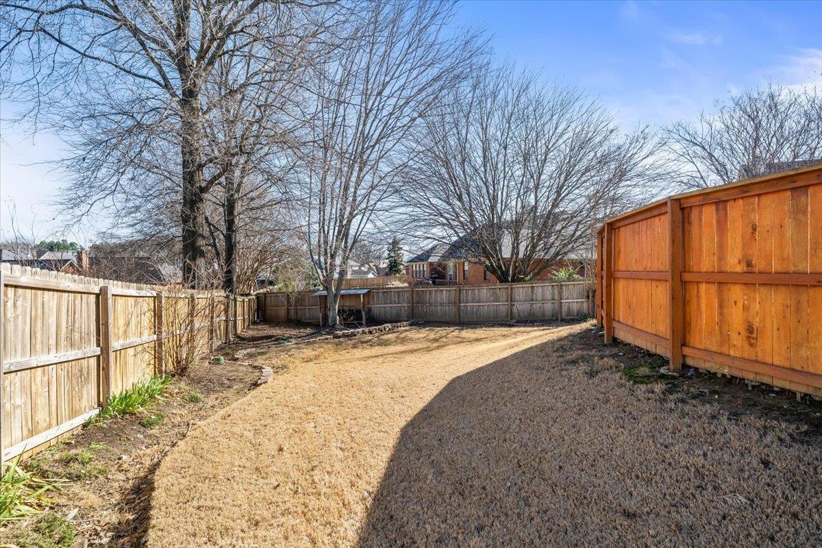 3204 Falling Star Cove Bartlett, TN 38134 - Photo 33 of 36 a view of backyard with large trees