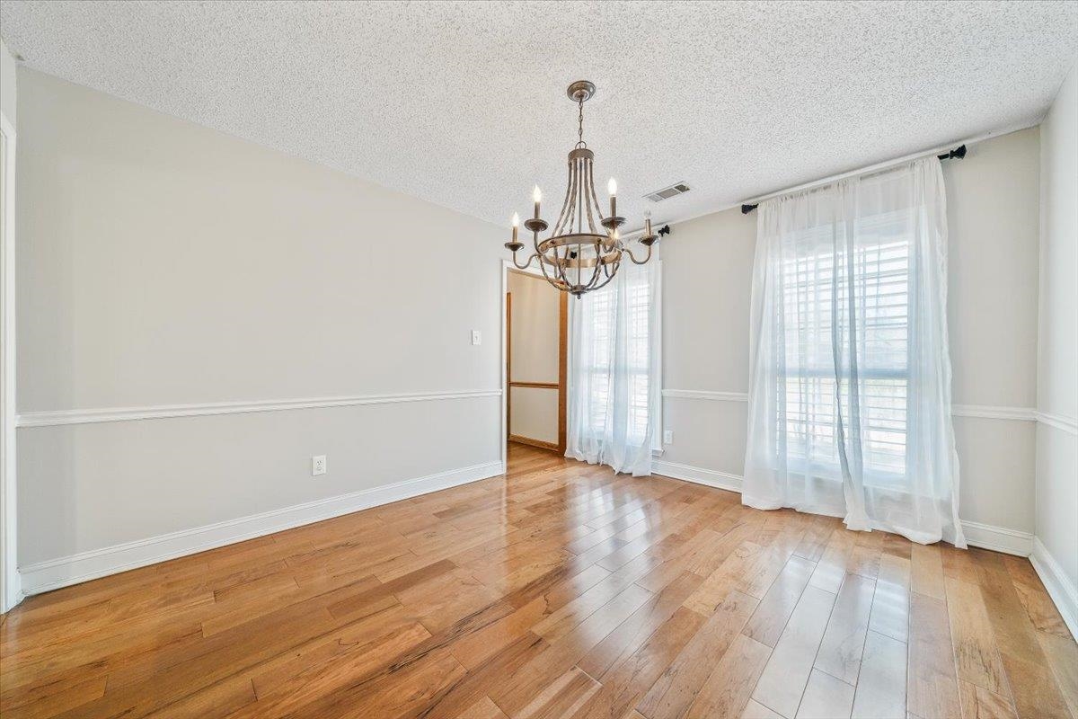 3204 Falling Star Cove Bartlett, TN 38134 - Photo 8 of 36 wooden floor in an empty room with a window