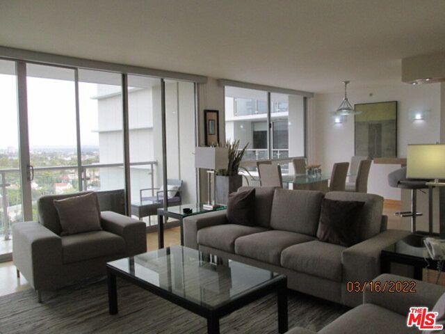 a kitchen with stainless steel appliances granite countertop a sink a stove and cabinets