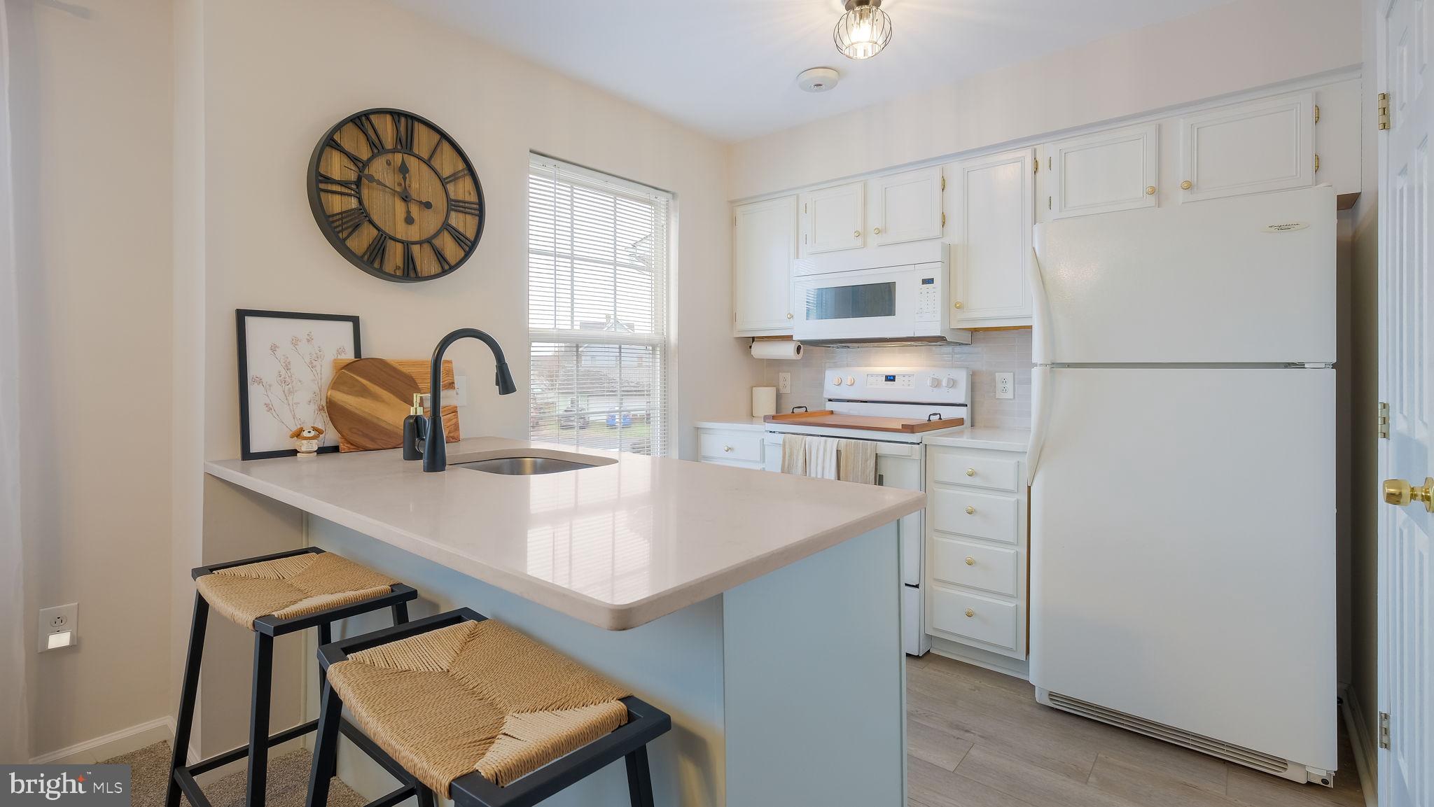 125 Catherine Street, Unit 5 Telford, PA 18969 - Photo 14 of 29 a kitchen with a refrigerator and a table in it
