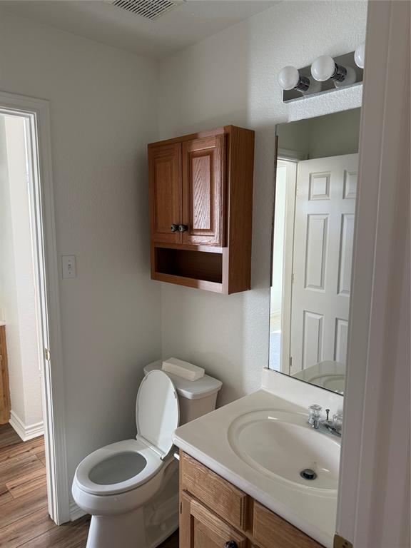 1451 Lakeside Trail Whitney, TX 76692 - Photo 11 of 18 a bathroom with a toilet sink and mirror