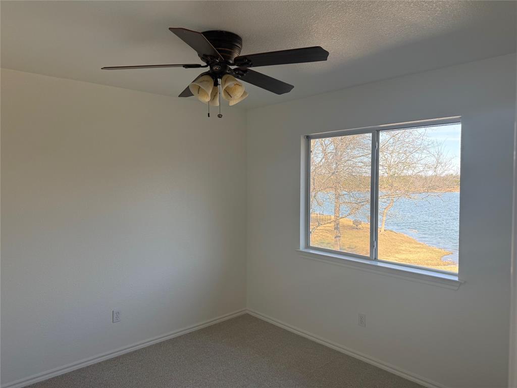 1451 Lakeside Trail Whitney, TX 76692 - Photo 16 of 18 an empty room with a window and a fan