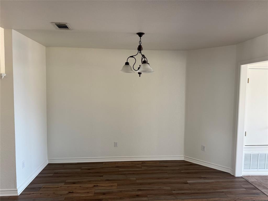 1451 Lakeside Trail Whitney, TX 76692 - Photo 6 of 18 a view of a room with wooden floor and white walls