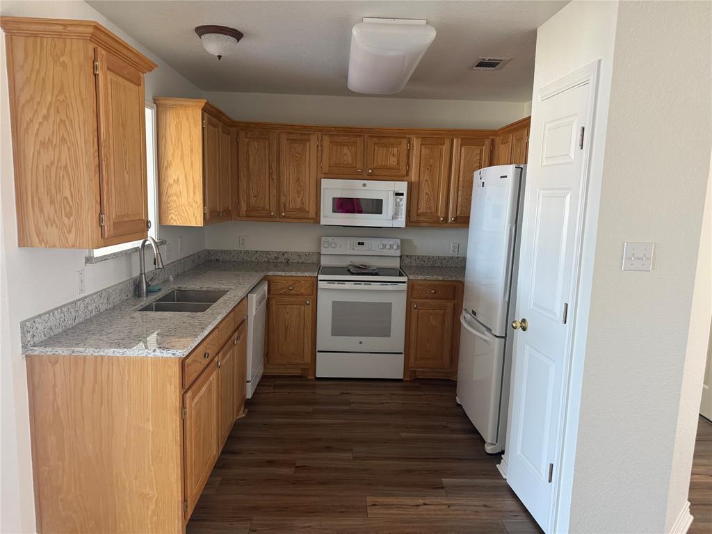 1451 Lakeside Trail Whitney, TX 76692 - Photo 7 of 18 a kitchen with a sink stove and refrigerator
