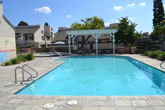 an outdoor space with pool and furniture
