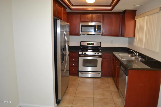 a kitchen with a stove microwave and refrigerator
