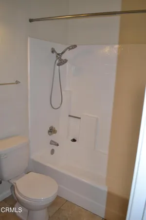 a bathroom with a shower and a toilet