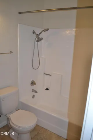 a bathroom with a shower and a toilet