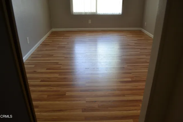 a view of wooden floor in an empty room