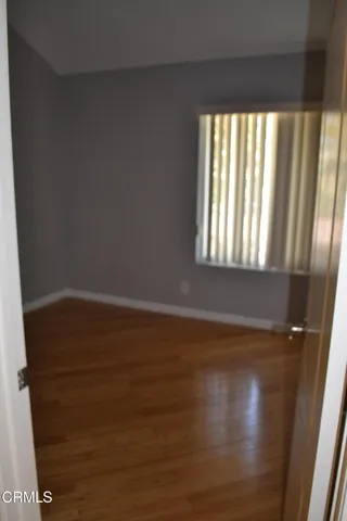 a view of wooden floor and windows in a room