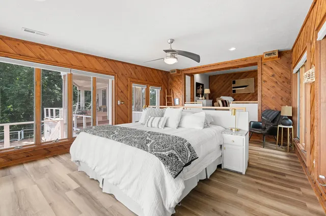 a spacious bedroom with a large bed and a large window