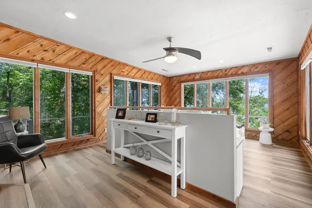 a view of a livingroom with furniture wooden floor and windows