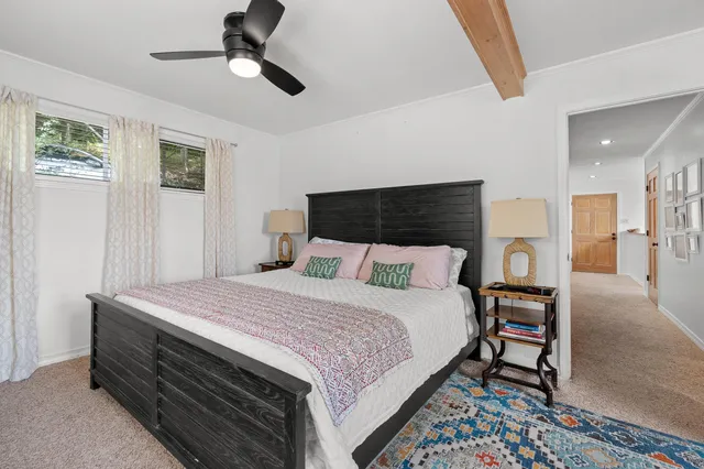 a bathroom with a granite countertop sink a toilet and a mirror
