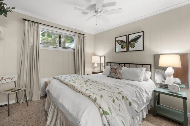 a bedroom with a bed and a chair