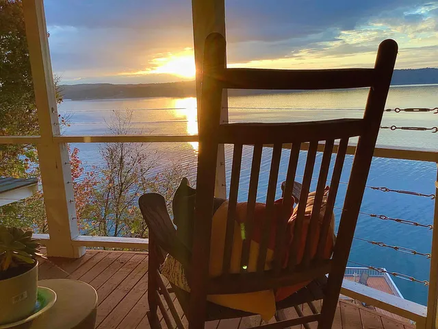 a view of a balcony with chair and wooden floor