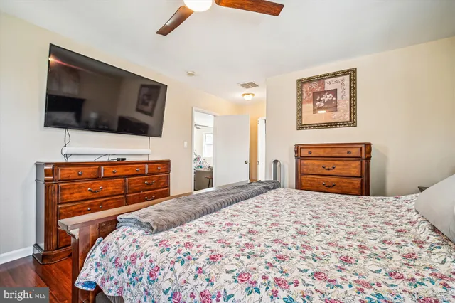 a bedroom with a bed and flat screen tv