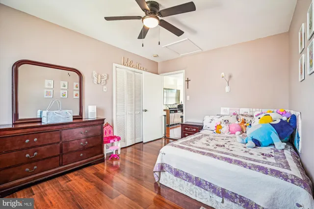 a bedroom with a bed and a mirror on the dresser