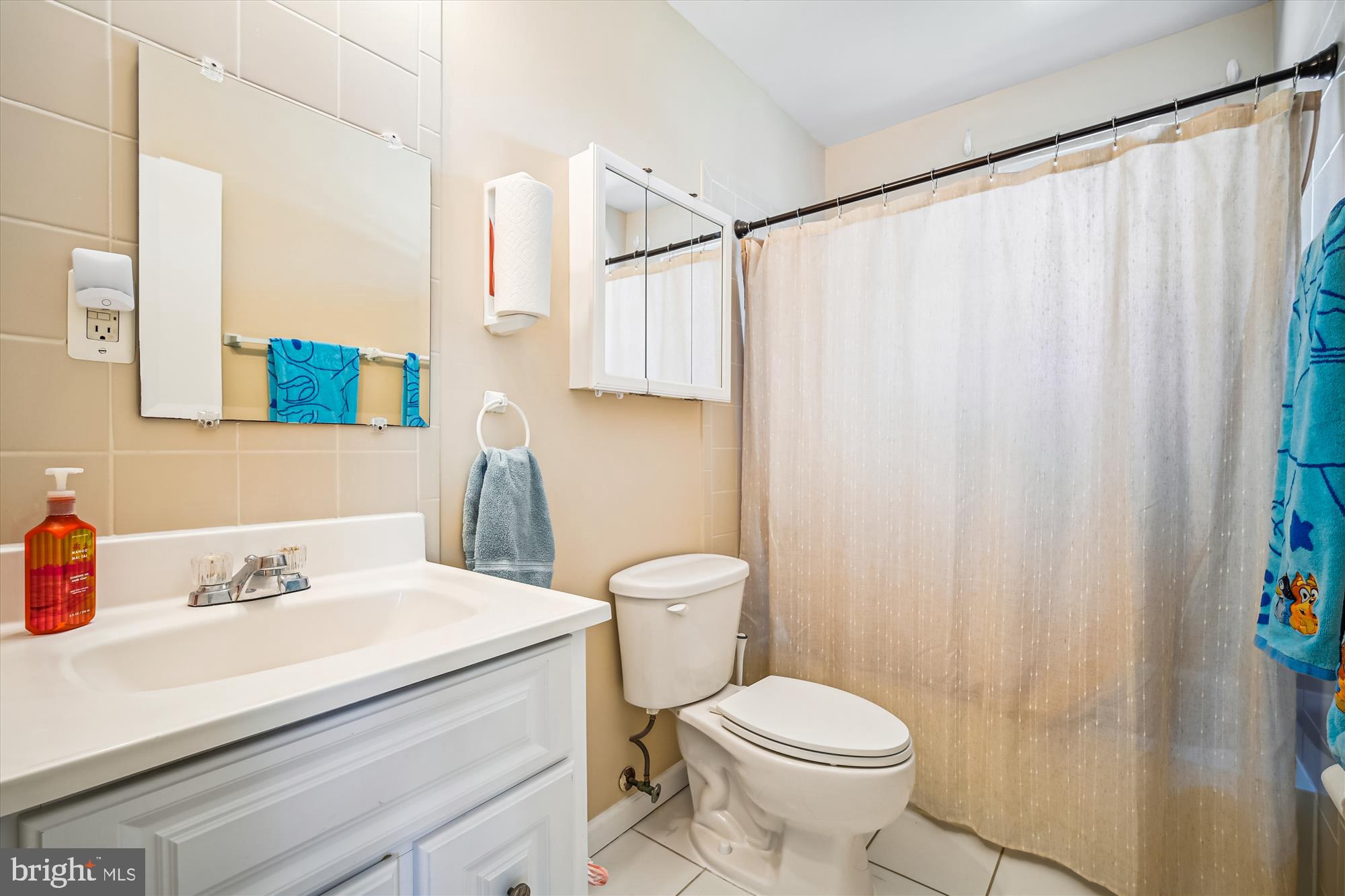7314 Inzer Street Springfield, VA 22151 - Photo 18 of 37 a bathroom with a sink a toilet and shower curtain