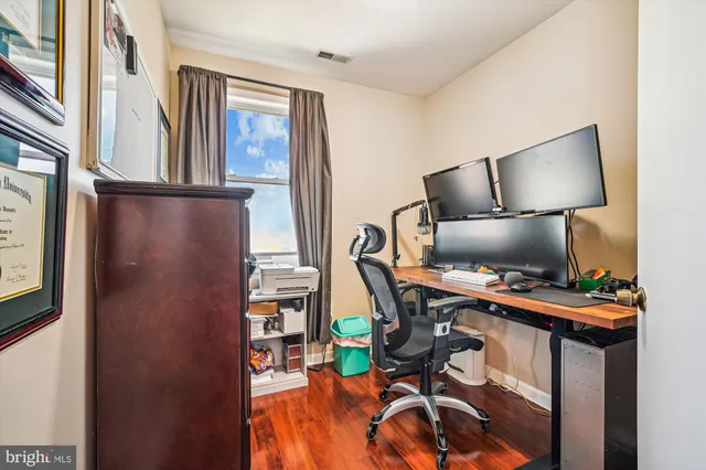 a view of a workspace with furniture and a lamp