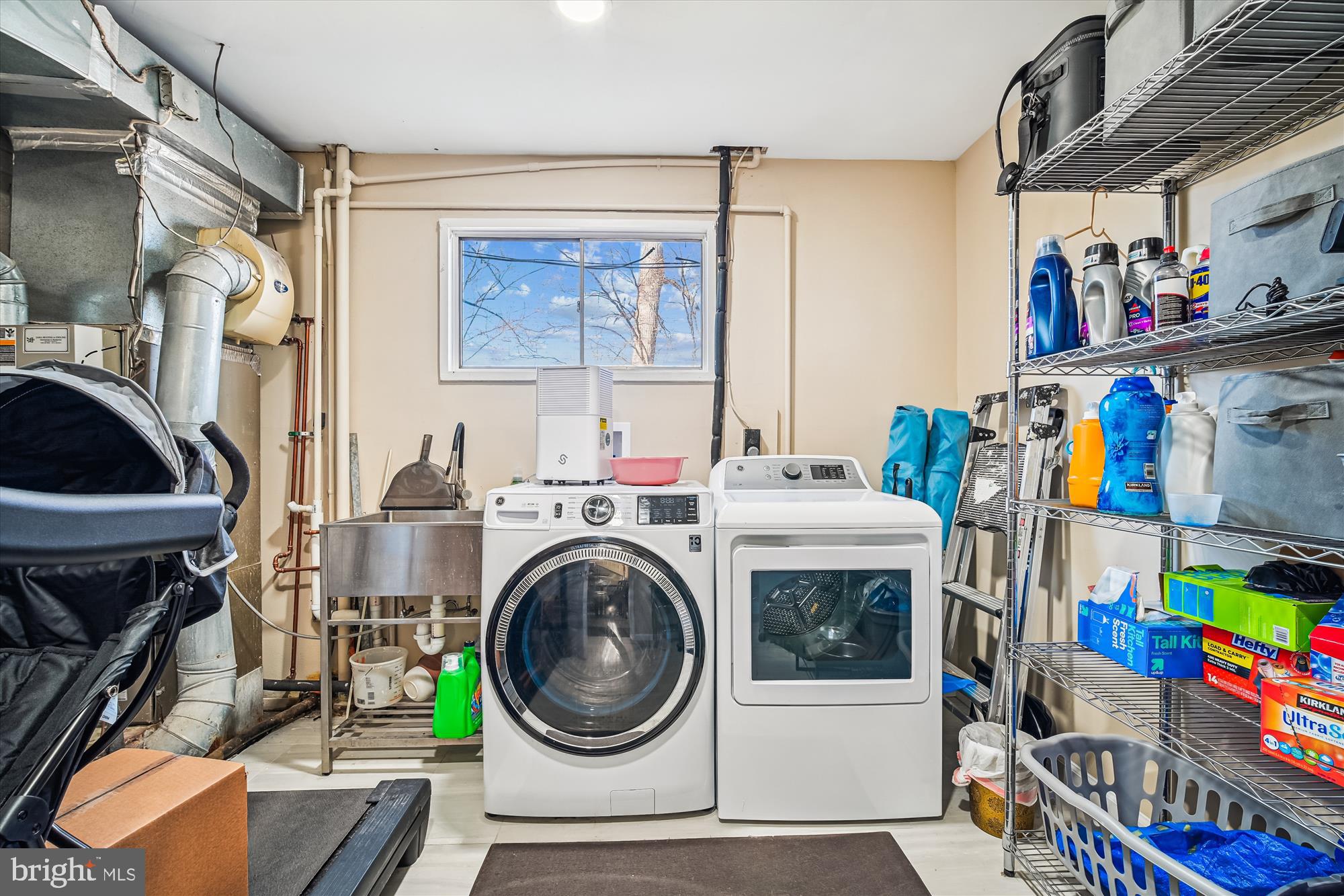 7314 Inzer Street Springfield, VA 22151 - Photo 10 of 37 a utility room with dryer washer and a flat screen tv