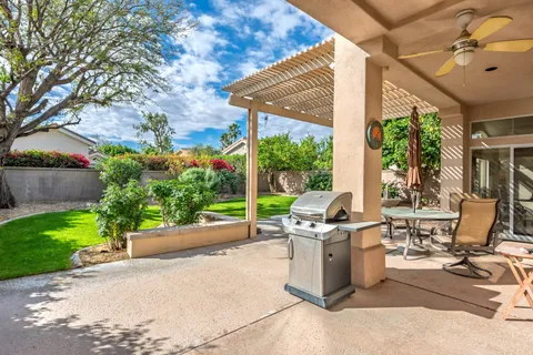 a view of a patio with a table and chairs and potted plants
