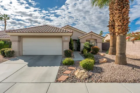 a front view of a house with a yard and a garage