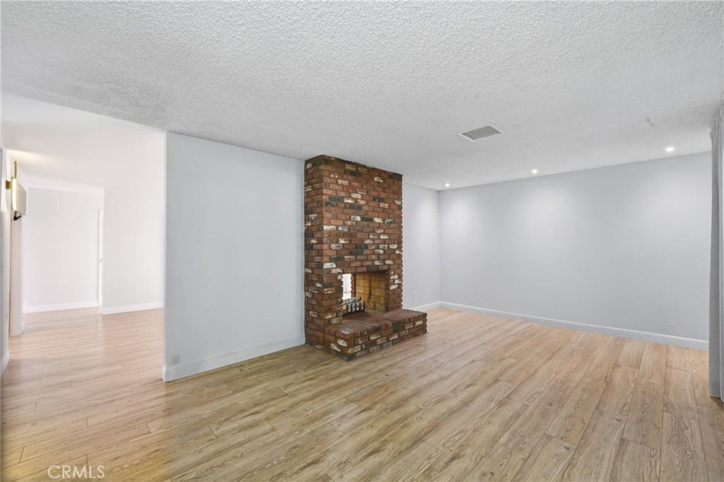 6255 Mitchell Avenue Riverside, CA 92505 - Photo 11 of 54 a view of an empty room with wooden floor and a window