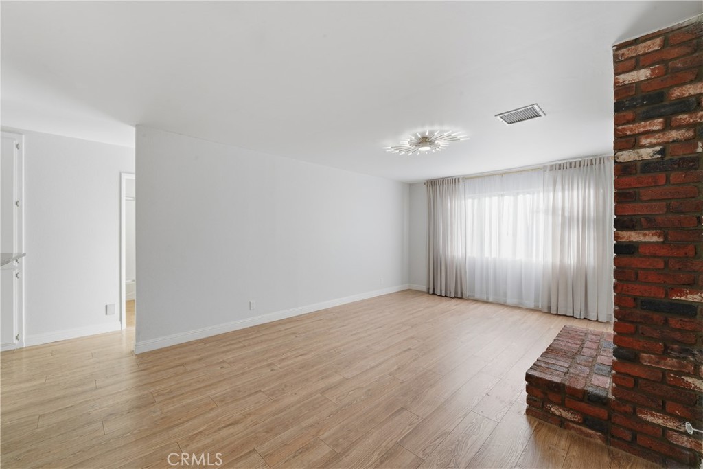 6255 Mitchell Avenue Riverside, CA 92505 - Photo 12 of 54 a view of a room with wooden floor and window
