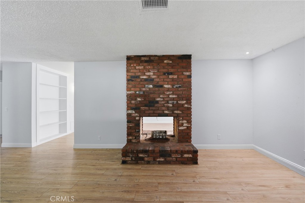 6255 Mitchell Avenue Riverside, CA 92505 - Photo 14 of 54 a room with a table and a fireplace