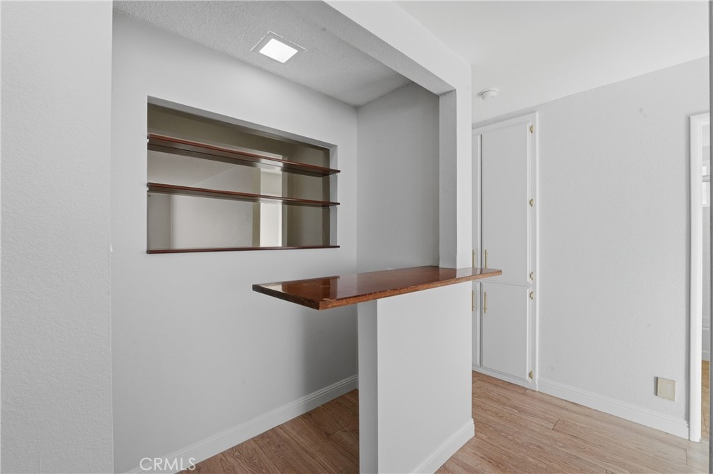 6255 Mitchell Avenue Riverside, CA 92505 - Photo 16 of 54 a view of an empty room with wooden floor and a window
