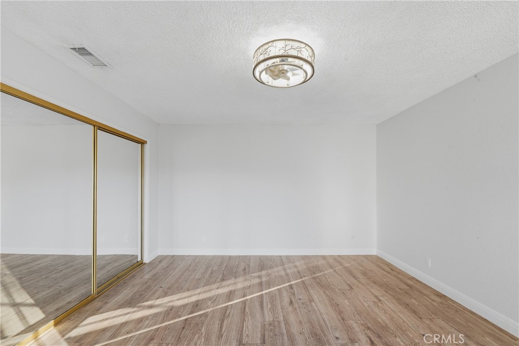 6255 Mitchell Avenue Riverside, CA 92505 - Photo 20 of 54 a view of a room with wooden floor and a ceiling fan