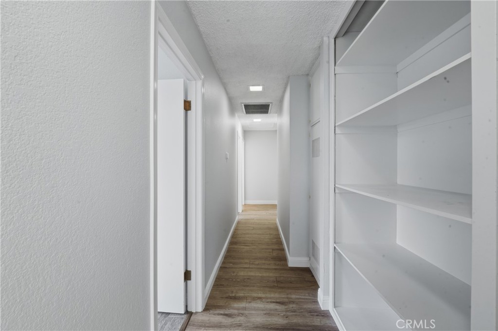 6255 Mitchell Avenue Riverside, CA 92505 - Photo 26 of 54 a view of a hallway with wooden floor