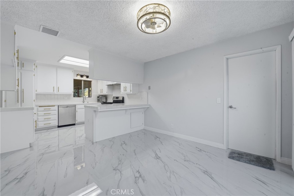 6255 Mitchell Avenue Riverside, CA 92505 - Photo 4 of 54 a view of kitchen with granite countertop white cabinets and stainless steel appliances
