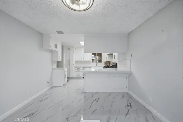 a view of a room with wooden floor and window