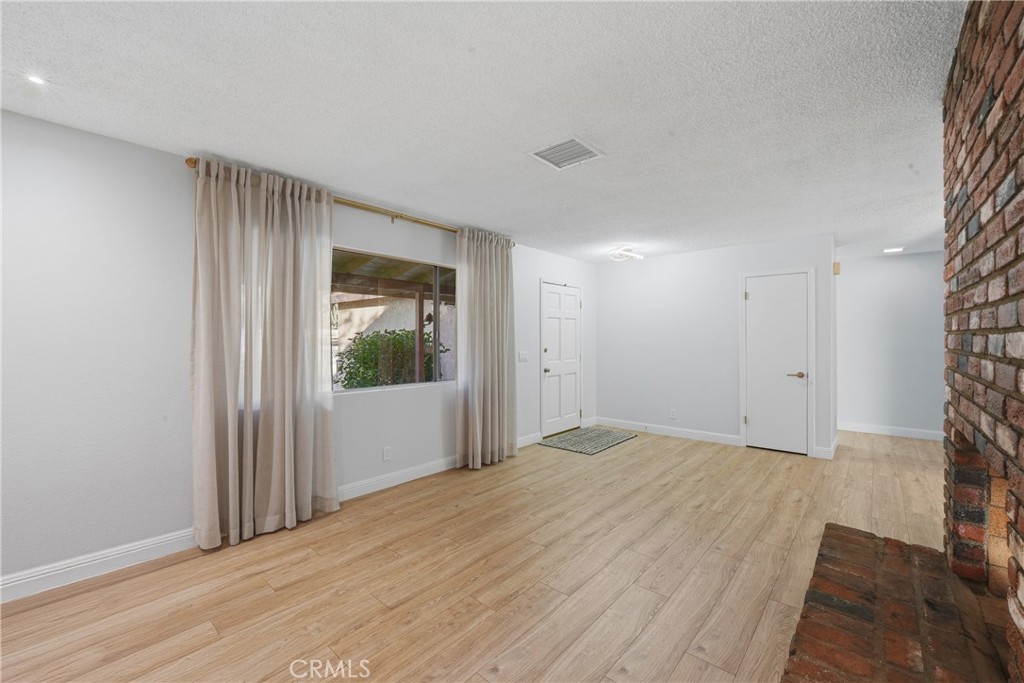 6255 Mitchell Avenue Riverside, CA 92505 - Photo 9 of 54 a view of empty room with wooden floor