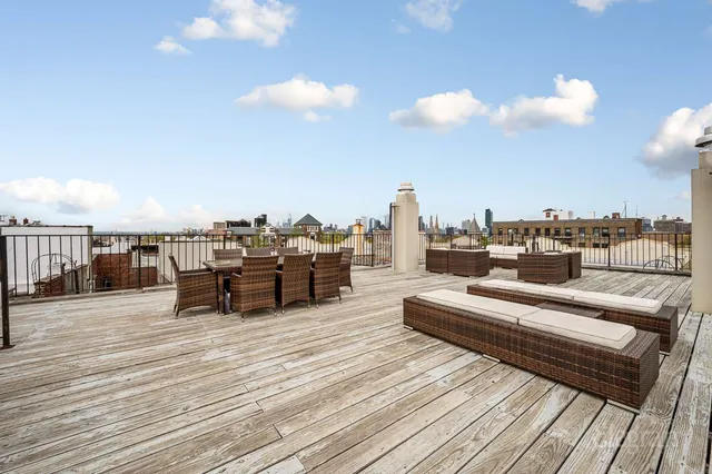 a bedroom with a bed a computer on the desk and a window