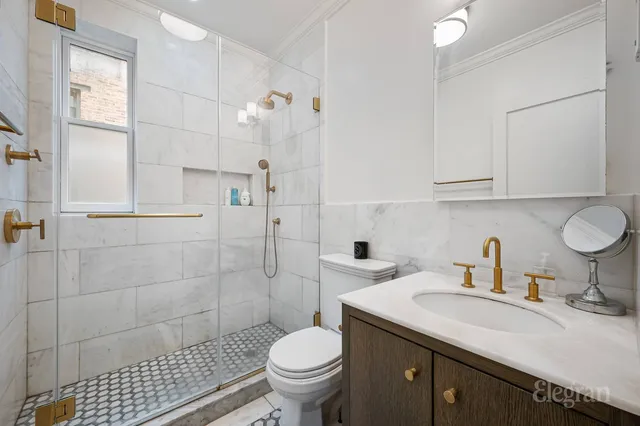 a bedroom with a bed and a flat tv screen on dresser