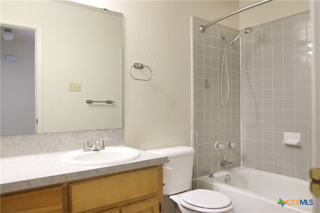 2406 Boyd Avenue Killeen, TX 76543 - Photo 20 of 22 a bathroom with a sink toilet vanity and shower