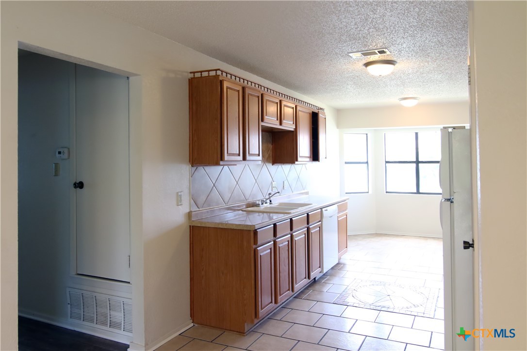 2406 Boyd Avenue Killeen, TX 76543 - Photo 8 of 22 a kitchen with stainless steel appliances granite countertop a stove and a refrigerator