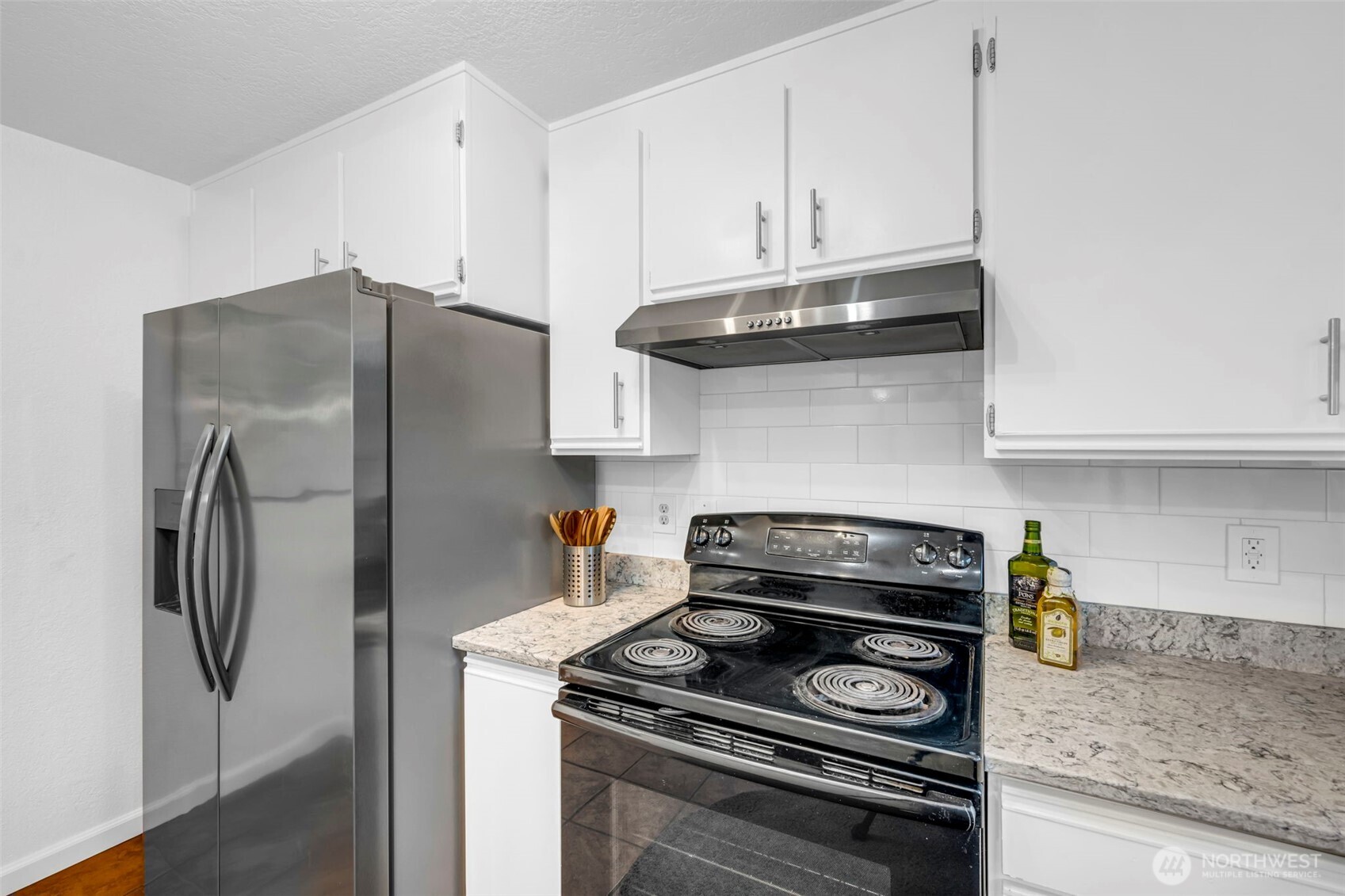 816 North 175th Street, Unit 2 Shoreline, WA 98133 - Photo 16 of 40 a kitchen with stainless steel appliances granite countertop a stove and a refrigerator