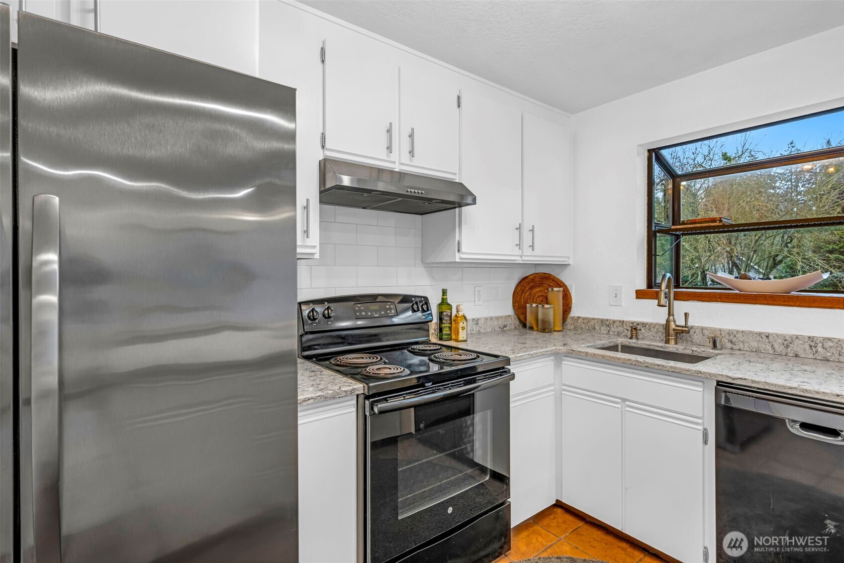 816 North 175th Street, Unit 2 Shoreline, WA 98133 - Photo 18 of 40 a kitchen with stainless steel appliances granite countertop a stove and a sink