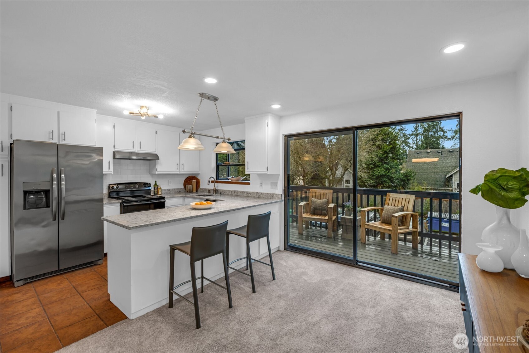 816 North 175th Street, Unit 2 Shoreline, WA 98133 - Photo 20 of 40 a kitchen with kitchen island a large window cabinets and stainless steel appliances