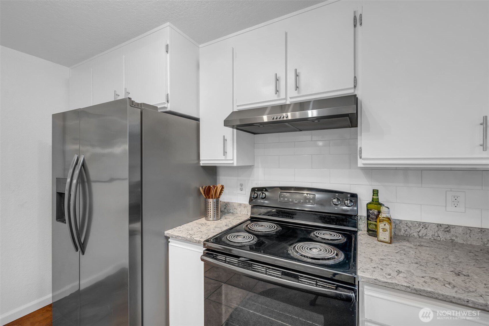 816 North 175th Street, Unit 2 Shoreline, WA 98133 - Photo 24 of 40 a kitchen with stainless steel appliances granite countertop a stove and a refrigerator