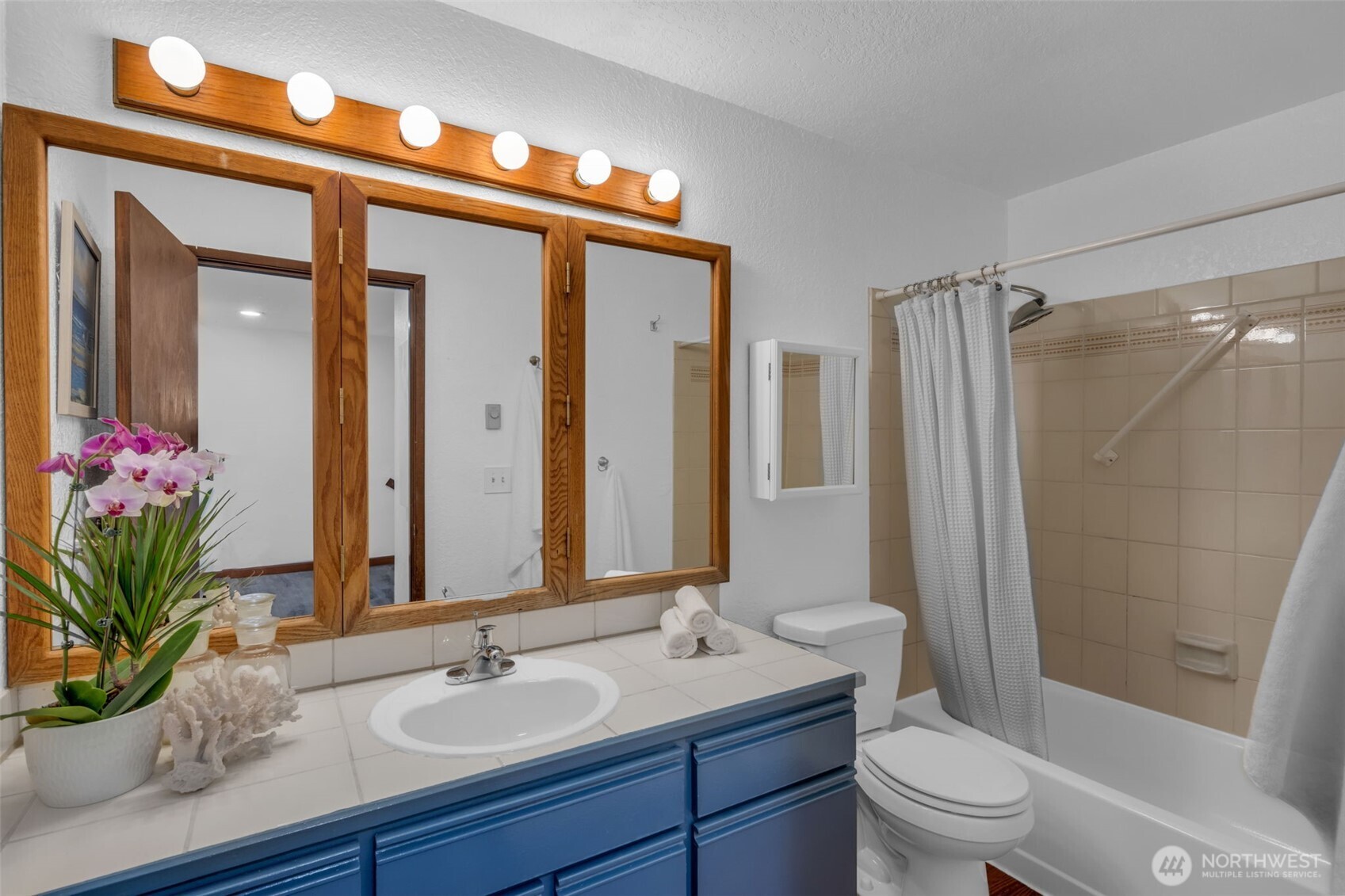 816 North 175th Street, Unit 2 Shoreline, WA 98133 - Photo 30 of 40 a bathroom with a granite countertop sink a toilet a mirror and shower