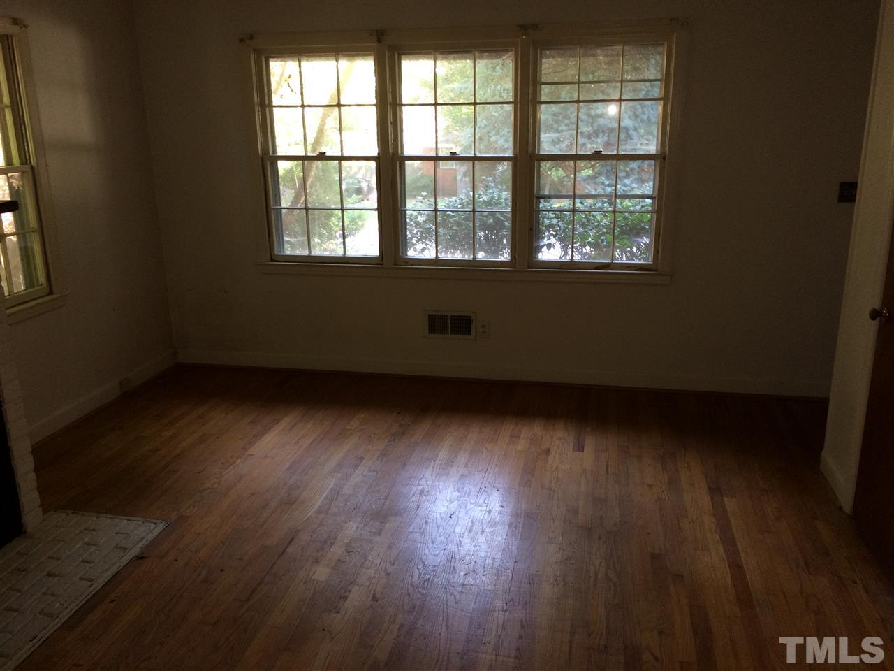 3129 Ward Road Raleigh, NC 27604 - Photo 4 of 9 an empty room with wooden floor and windows