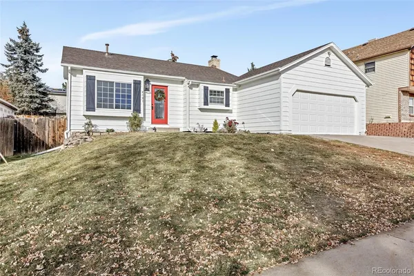 a view of a house with a yard and garage