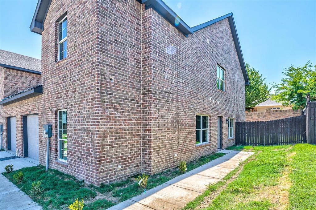 a brick building with a yard