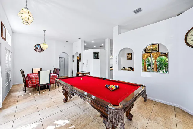 a bedroom with bed and a chandelier
